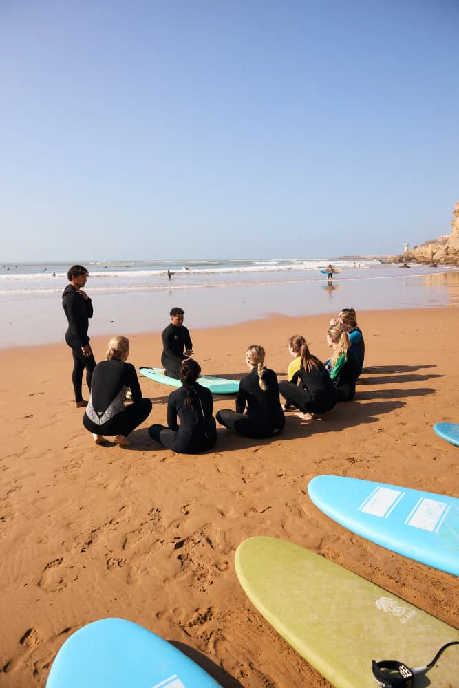 Beach surf lesson opening circle at Aman Surf & Yoga in Imsouane, Morocco