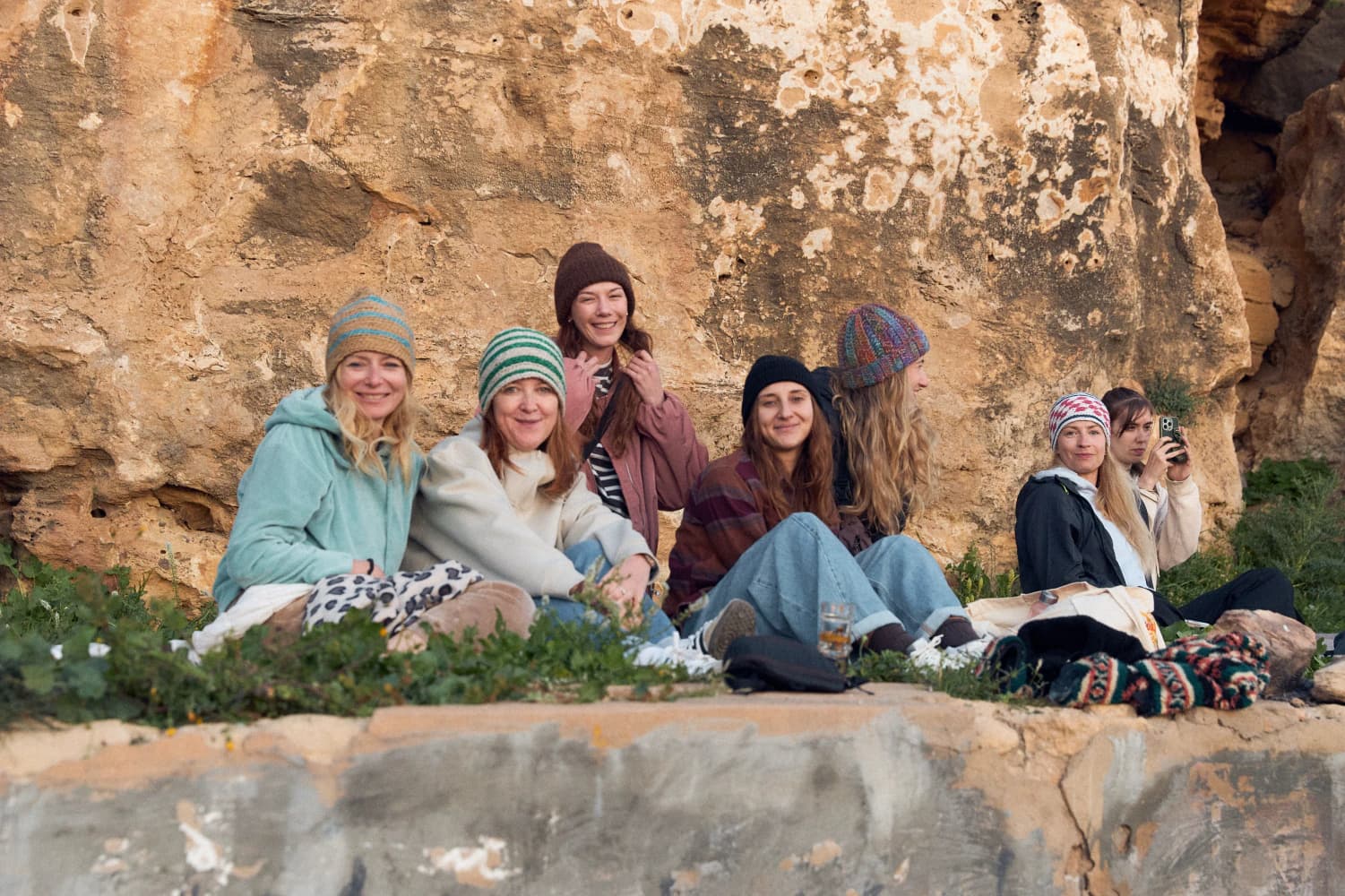 Friends portrait by coastal cliff at Aman Surf & Yoga in Imsouane, Morocco