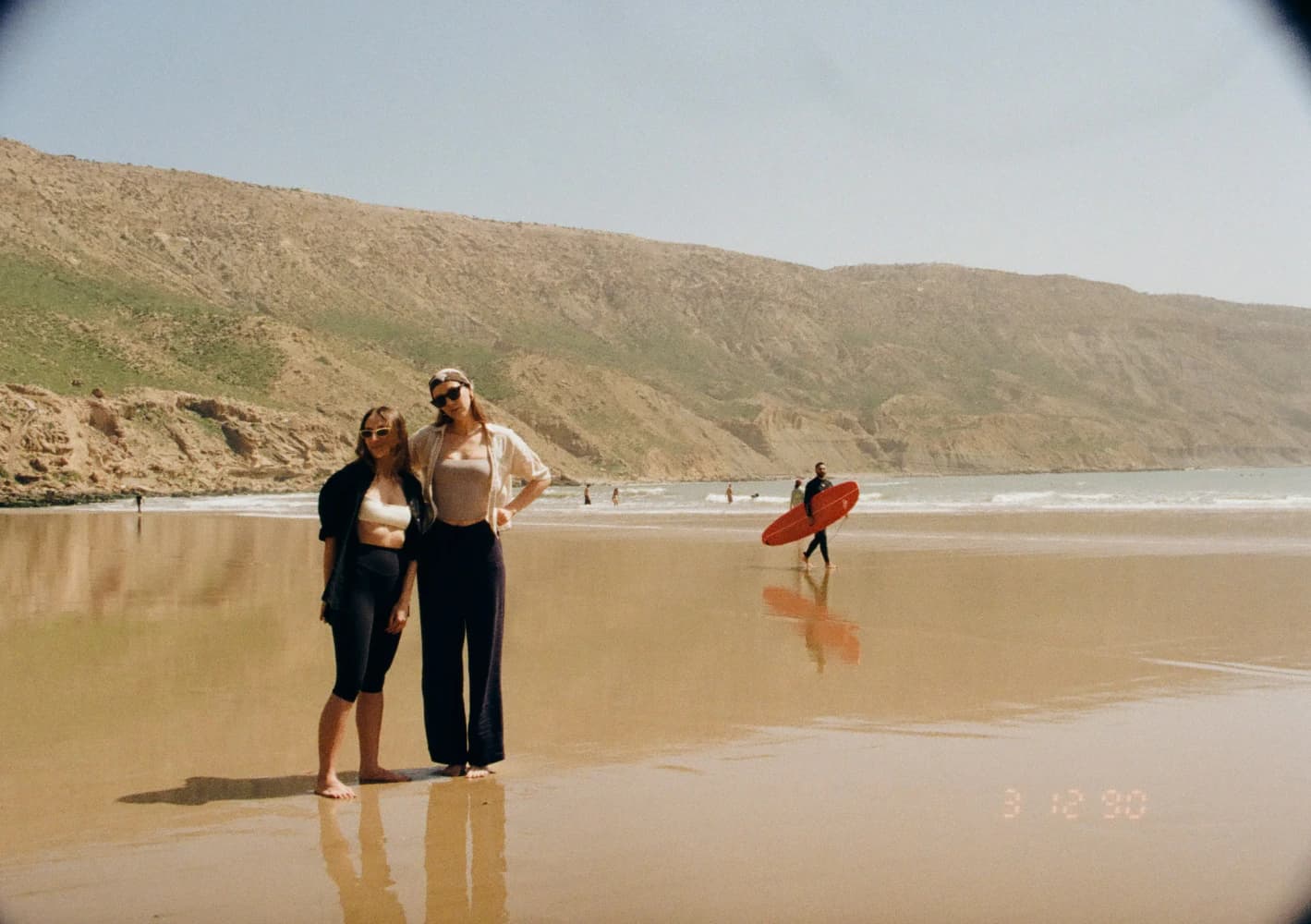 Friends walking on beach at Aman Surf & Yoga in Imsouane, Morocco