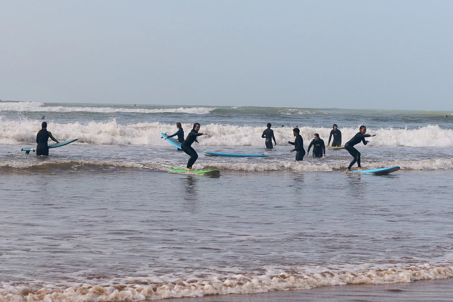 Group surf practice in shore break at Aman Surf & Yoga in Imsouane, Morocco