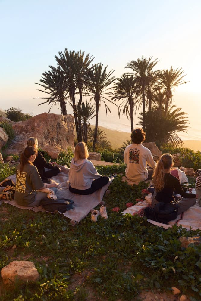 Meditation circle facing palm grove at Aman Surf & Yoga in Imsouane, Morocco
