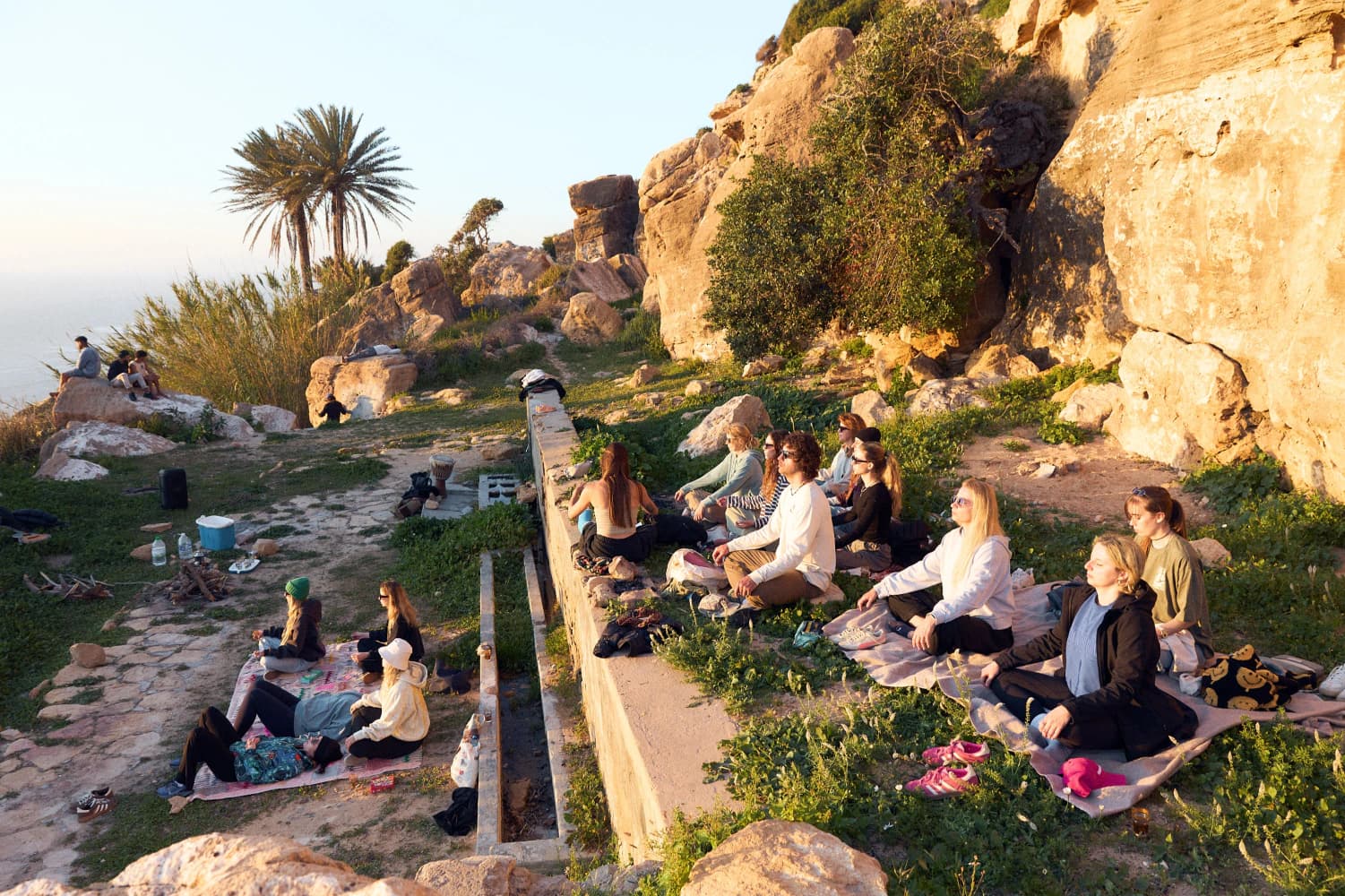 Outdoor wellness session by rocks at Aman Surf & Yoga in Imsouane, Morocco