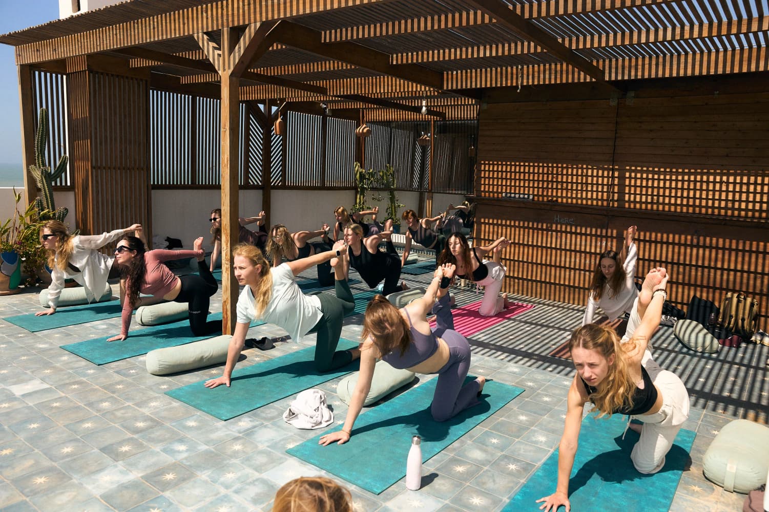 Rooftop yoga tabletop flow at Aman Surf & Yoga in Imsouane, Morocco