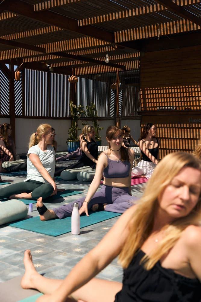 Seated rooftop yoga class at Aman Surf & Yoga in Imsouane, Morocco