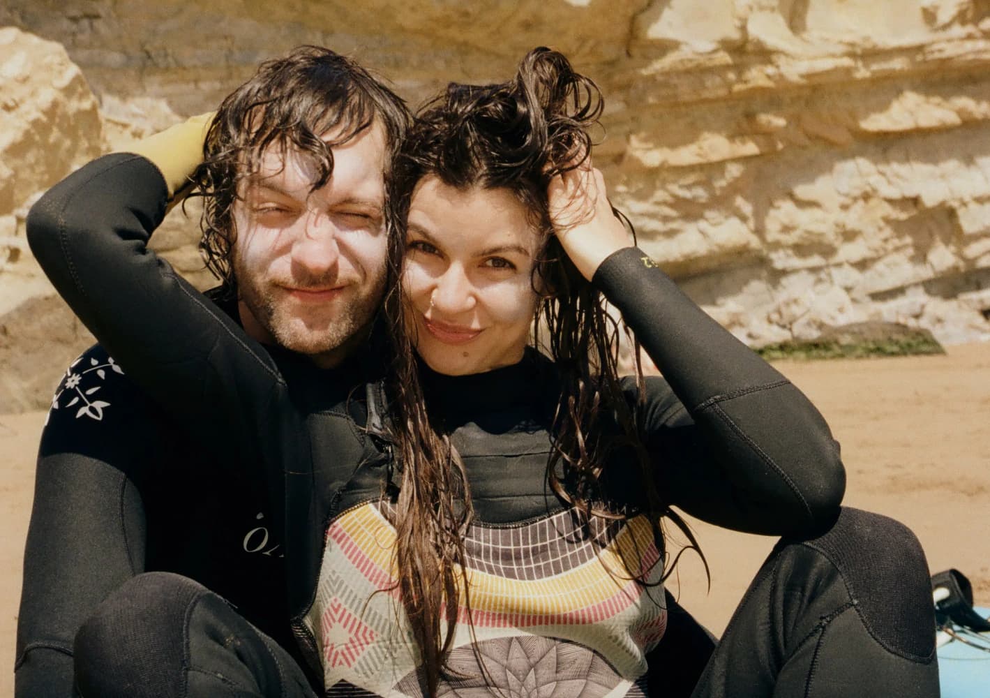 Smiling surfers in wetsuits at Aman Surf & Yoga in Imsouane, Morocco