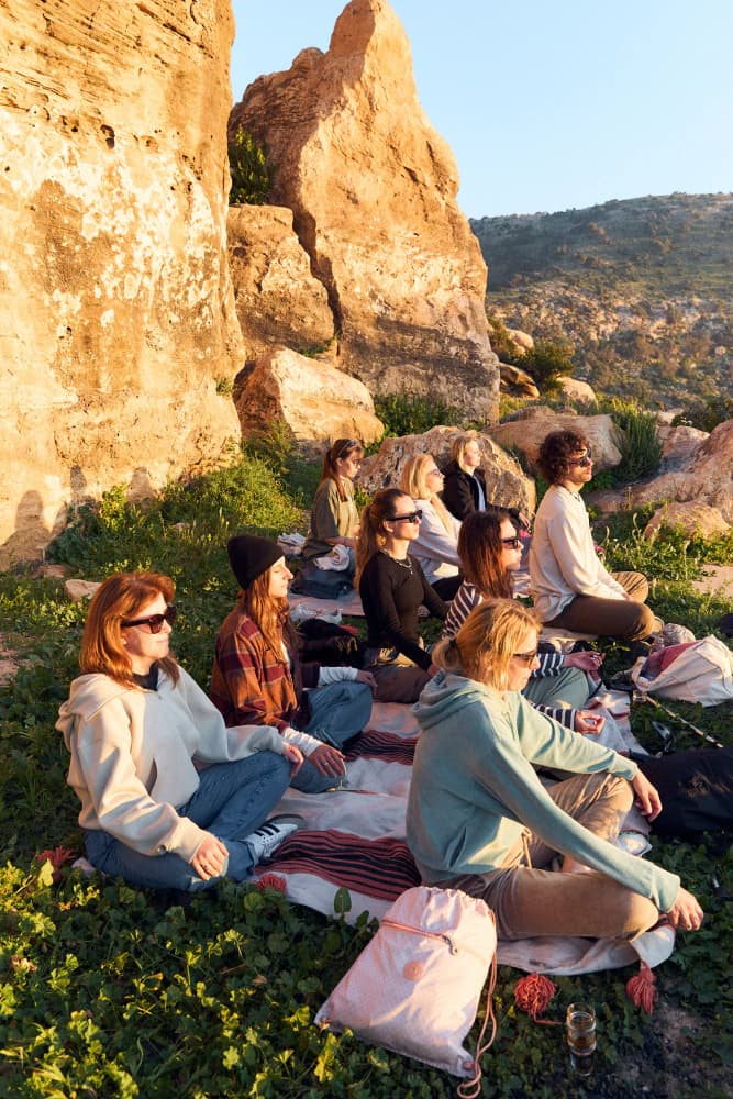 Sunset meditation by cliffs at Aman Surf & Yoga in Imsouane, Morocco