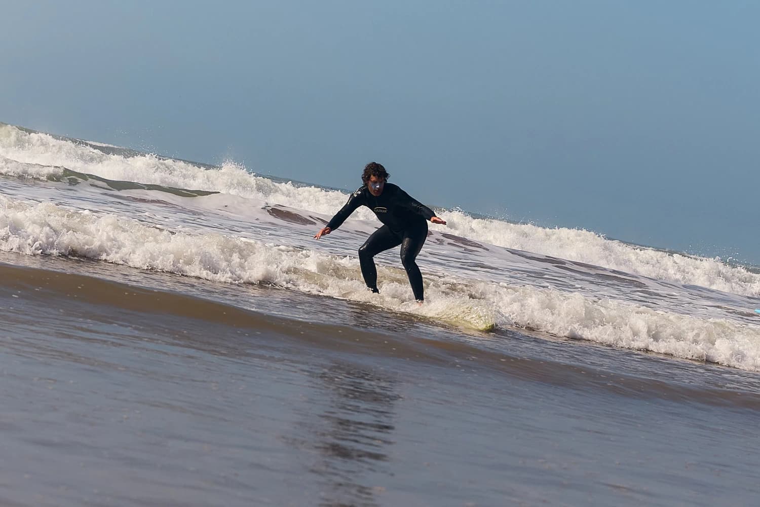 Surfer riding whitewater wave at Aman Surf & Yoga in Imsouane, Morocco