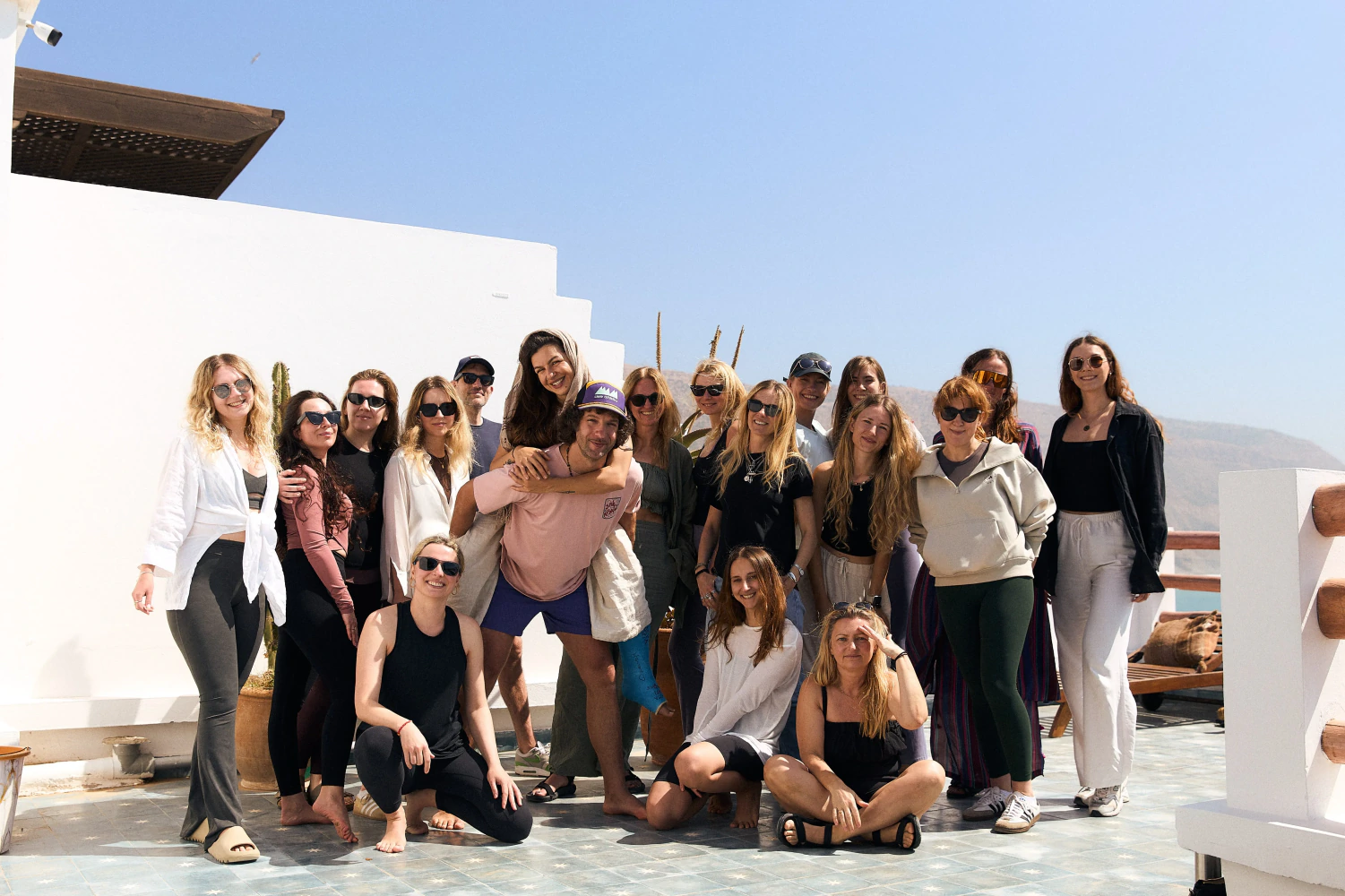 Aman Surf & Yoga guests smiling together after a rooftop yoga session in Imsouane, Morocco